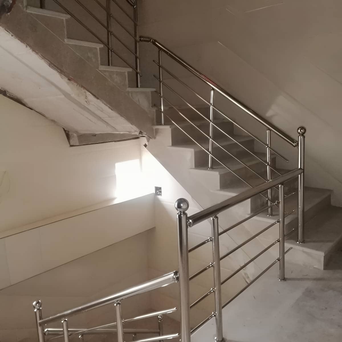 نرده استیل طلایی با پایه محکم کنار سنگ روشن نرده استیل طلایی با پایه محکم کنار سنگ روشن